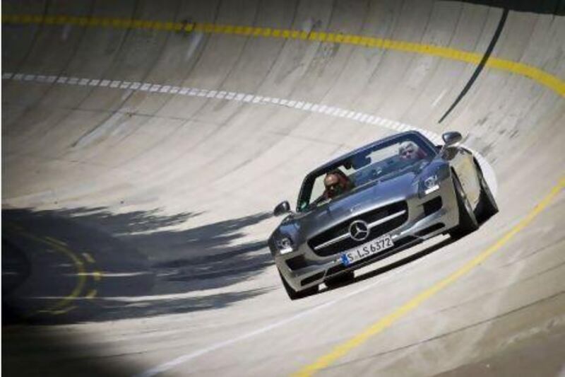 US chat show host Jay Leno finds out how much the SLS AMG Roadster hugs the road on Mercedes' banked track in Stuttgart. Courtesy of Patrick Gosling