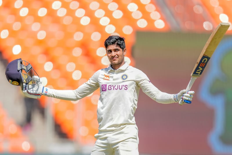 India's Shubman Gill raises his bat to celebrate his century. AP