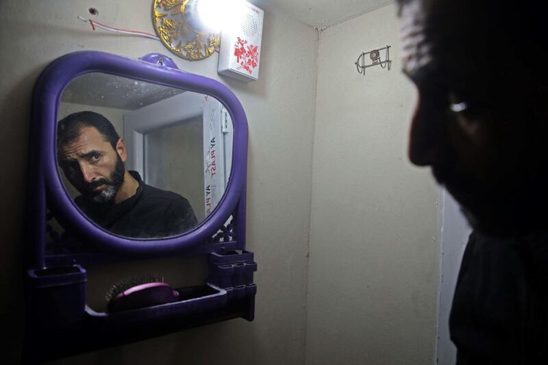 A man suffering from mental issues looks at himself in a mirror at al-Waalan special needs centre in Aldana, Syria. AFP