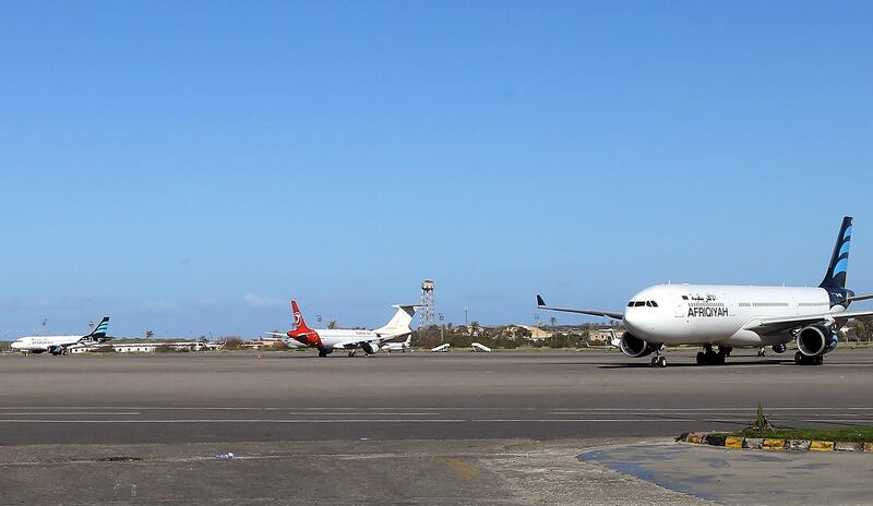 (FILES) In this file photo taken on April 08, 2019 Grounded air-planes sit on the tarmac at Mitiga International Airport in the Libyan capital Tripoli. Rocket fire on August 11 hit the Libyan capital's sole functioning airport, violating a temporary truce between the unity government and forces loyal to strongman Khalifa Haftar, airport authorities said.


 / AFP / Mahmud TURKIA
