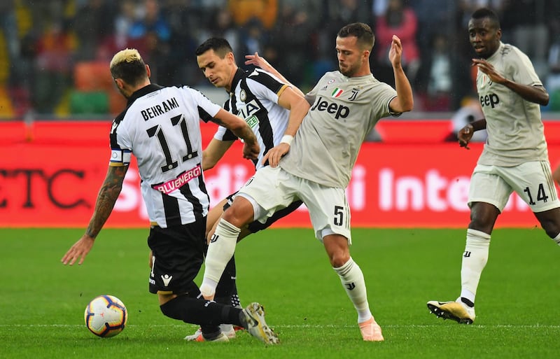 Miralem Pjanic, right, of Juventus competes for the ball with Kevin Lasagna of Udinese Calcio. Getty Images