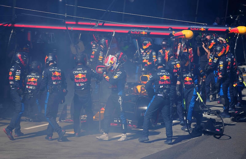 Max Verstappen walks back to the garage after smoke billowed from his car during the Australian Grand Prix. AFP