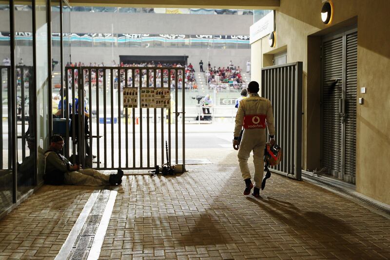 ABU DHABI, UNITED ARAB EMIRATES - NOVEMBER 04:  Lewis Hamilton of Great Britain and McLaren walks back to the pitlane after retiring early from the Abu Dhabi Formula One Grand Prix at the Yas Marina Circuit on November 4, 2012 in Abu Dhabi, United Arab Emirates.  (Photo by Ker Robertson/Getty Images) *** Local Caption ***  155452710.jpg