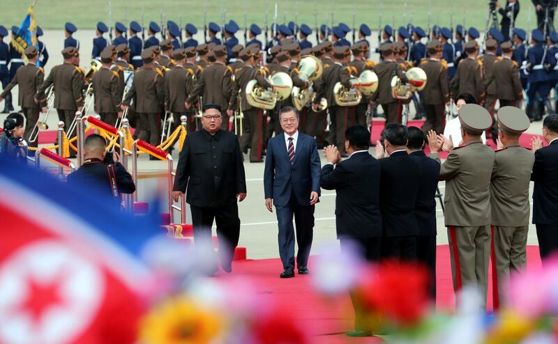Moon Jae-in and Kim Jong Un walk side by side at Pyongyang Sunan International Airport. Reuters