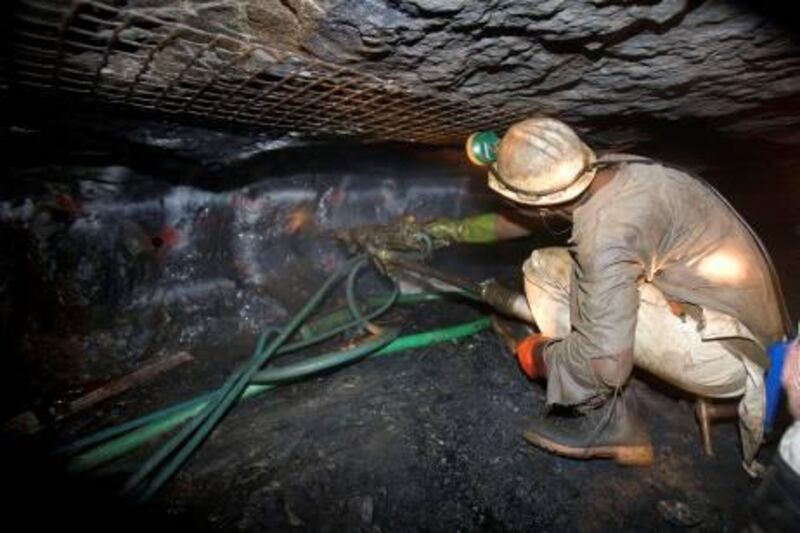 A mineworker works with a drill on the rock face at the Impala Platinum mine in Rustenburg, South Africa, on Wednesday, June 4, 2008. Impala Platinum Holdings Ltd is the world's second-biggest platinum producer. Photographer: Nadine Hutton/Bloomberg News