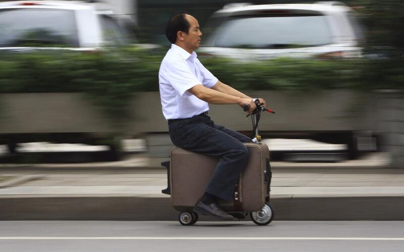 He Liang rides his home-made suitcase vehicle along a street in Changsha, Hunan province. He spent 10 years modifying the suitcase into a motor-driven vehicle. The suitcase has a top speed of up to 20km/h and the power capacity to travel up to 50-60km after one charge, according to local media. China Daily / Reuters