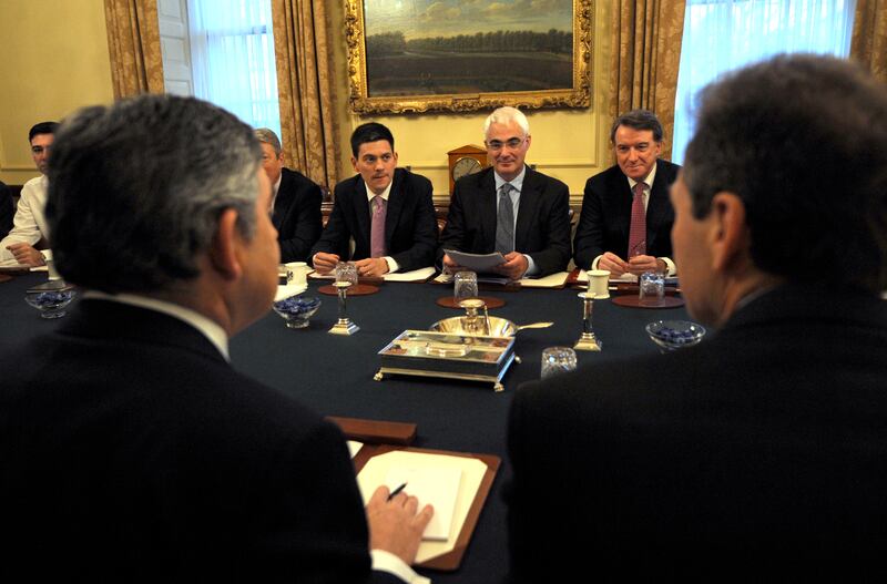 Gordon Brown speaks with Mr Darling during a cabinet meeting at 10 Downing Street in 2009