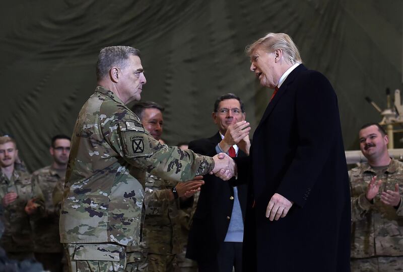 US President Donald Trump shakes hands with Joint Chiefs Chairman General Mark Milley before addressing the troops at Bagram Air Field during a surprise Thanksgiving day visitin Afghanistan. AFP