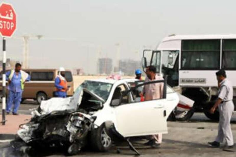 Police attend a car accident outside the Etihad headquarters in Abu Dhabi's airport district.