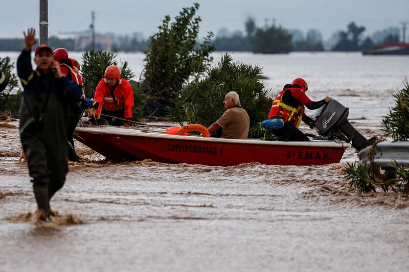 Rescuers move people to safety after Storm Daniel caused flooding in Astritsa, Greece. Reuters