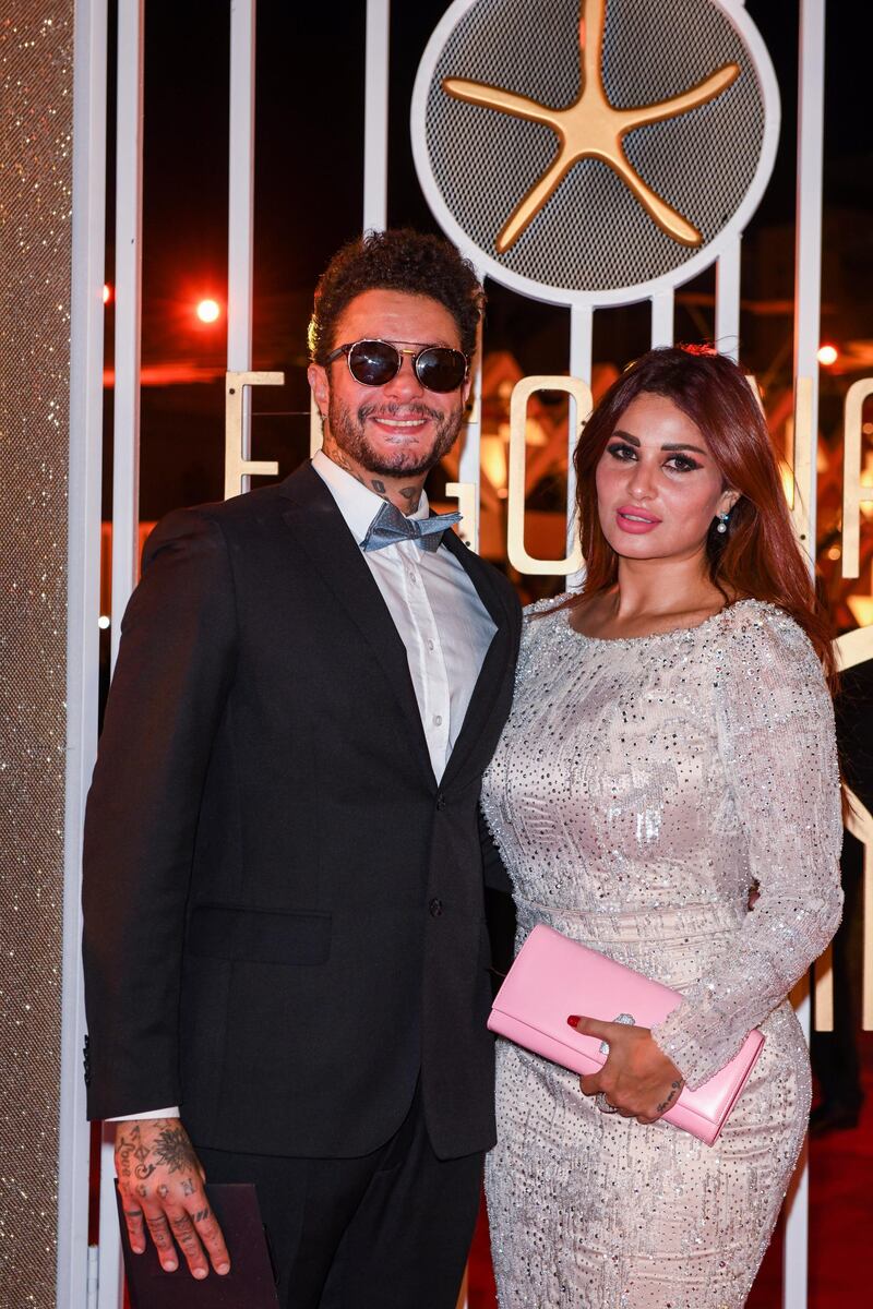 Egyptian actor Ahmad Fishawi and wife Nada Kamel pose for a photo as they walk the red carpet during the opening ceremony of the 3rd edition of El Gouna Film Festival, in the Egyptian Red Sea resort of el-Gouna, on September 19, 2019. (Photo by Ammar Abd Rabbo / El Gouna Film Festival / AFP) / RESTRICTED TO EDITORIAL USE