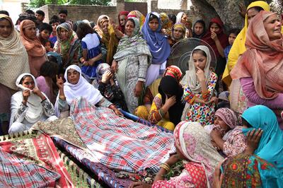 People attend funeral Pakistani villagers allegedly killed by Indian shelling in Khanoor Mian, along the Line of Control in Pakistan, Friday, May 18, 2018. Pakistani military accused Indian troops of initiating an "unprovoked" violation of the 2003 cease-fire accord between the two countries along the frontier near Kashmir and targeting the civilian population, including scores of villagers who died Friday morning. (AP Photo/Shahif Ikram)