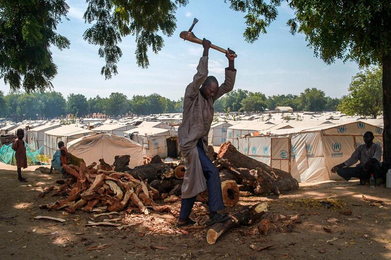 An IDP-camp resident in Bama chops firewood in the camp. Firewood is a precious commodity for many IDPs in Borno, and people often trade food and other essential items for it. Without fire and fuel to cook, IDPs cannot cook the food rations that are distributed for them.