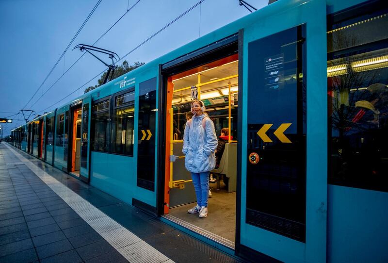 A passenger wears a face mask as she waits for a subway to leave in Frankfurt, Germany. AP Photo