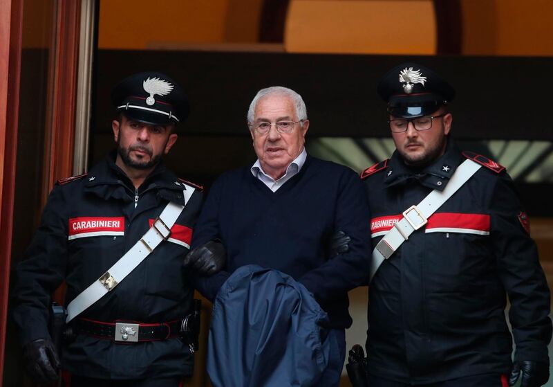 CORRECTS FIRST NAME TO SETTIMO, NOT SETTIMINO - Settimo Mineo, center, who allegedly took over as the Palermo head of Cosa Nostra, is escorted by Italian Carabinieri police after an anti Mafia operation which led the arrest of 46 people including the presumed regional boss, in Palermo, Sicily, Italy, Tuesday, Dec. 4, 2018.  Italian police say they have dismantled the rebuilt upper echelons of the Sicilian Mafia. (Igor Petyx/ANSA via AP)