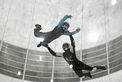 Abu Dhabi, United Arab Emirates - Samih, 9, takes flight with the help of the instructor during the indoor skydiving adventure at CLYMB, Yas Island. Khushnum Bhandari for The National