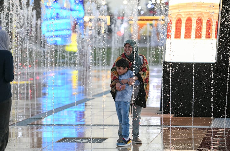 Visitors enjoy the central water fountain