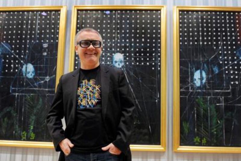 epa01895919 British artist Damien Hirst poses for photographs with 'Men Shall Know Nothing', 2008, part of his new exhibit, 'No Love Lost, Blue Paintings' at the Wallace Collection in London, Britain, 13 October 2009. 'Blue Paintings' marks Hirst's return to painting. The Wallace Collection is exhibiting 25 new paintings by Hirst including two triptychs, being shown in Britain for the first time.  EPA/ANDY RAIN *** Local Caption ***  01895919.jpg