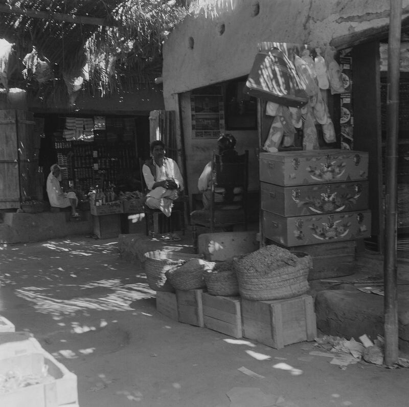 The interior of Abu Dhabi souq around 1960 with a shop selling bride chests or mandoos. Courtesy: BP Archive