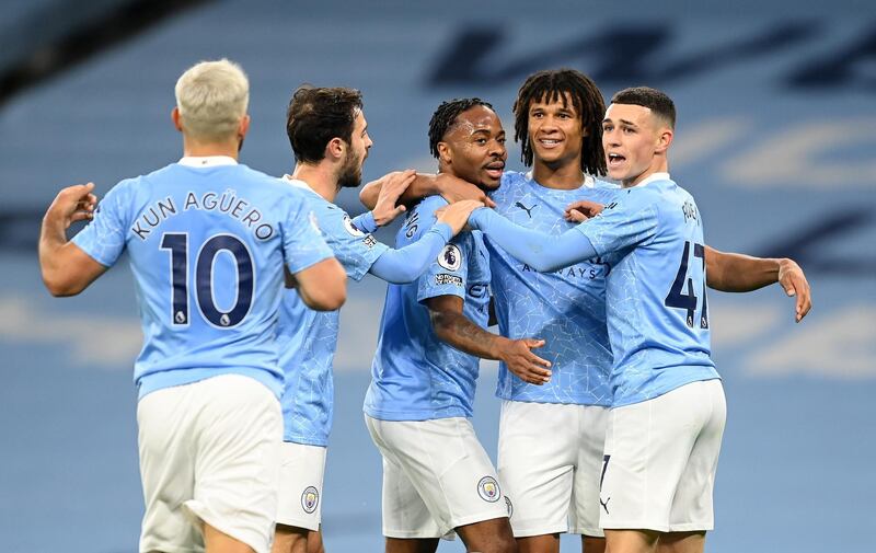 MANCHESTER, ENGLAND - OCTOBER 17: Raheem Sterling of Manchester City celebrates with teammates after scoring his team's first goal during the Premier League match between Manchester City and Arsenal at Etihad Stadium on October 17, 2020 in Manchester, England. Sporting stadiums around the UK remain under strict restrictions due to the Coronavirus Pandemic as Government social distancing laws prohibit fans inside venues resulting in games being played behind closed doors. (Photo by Michael Regan/Getty Images)