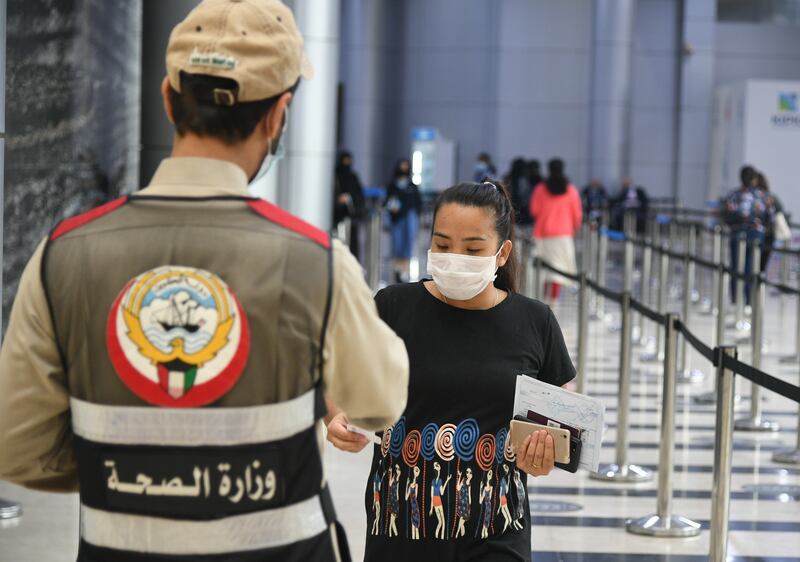 People arrive to receive a booster shot of the Covid-19 vaccine at a make-shift vaccination centre in Kuwait City. EPA