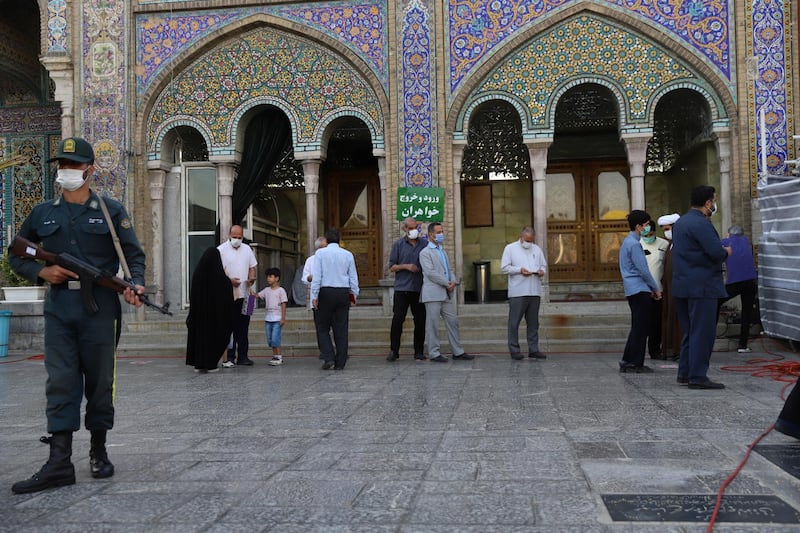 Iranians wait to vote at a polling station during presidential elections in the capital Tehran. Reuters