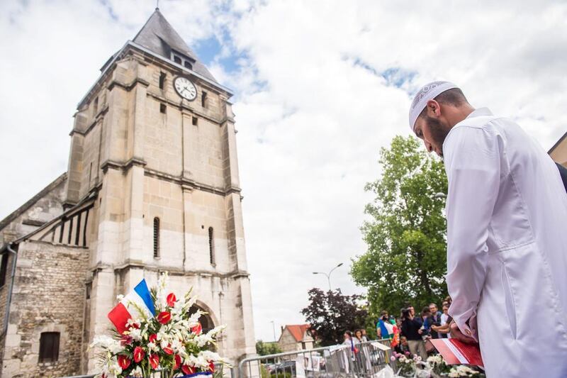 Muslim worshippers observe a minute of silence in front of the Saint Etienne church in Saint-Etienne-du-Rouvray, near Rouen, France, 29 July 2016. Four days after the hostage taking in the church of Saint Etienne du Rouvray, officials of the French Muslim community and Muslim worshippers paid tribute to the victim of the attack, priest Jacques Hamel, killed during the ISIL-linked attack on the church in Normandy.  Christophe Petit / EPA