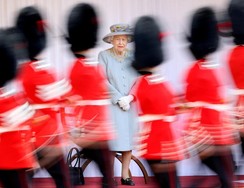 Britain's Queen Elizabeth II watches as members of the royal guard march at Windsor Castle. Reuters