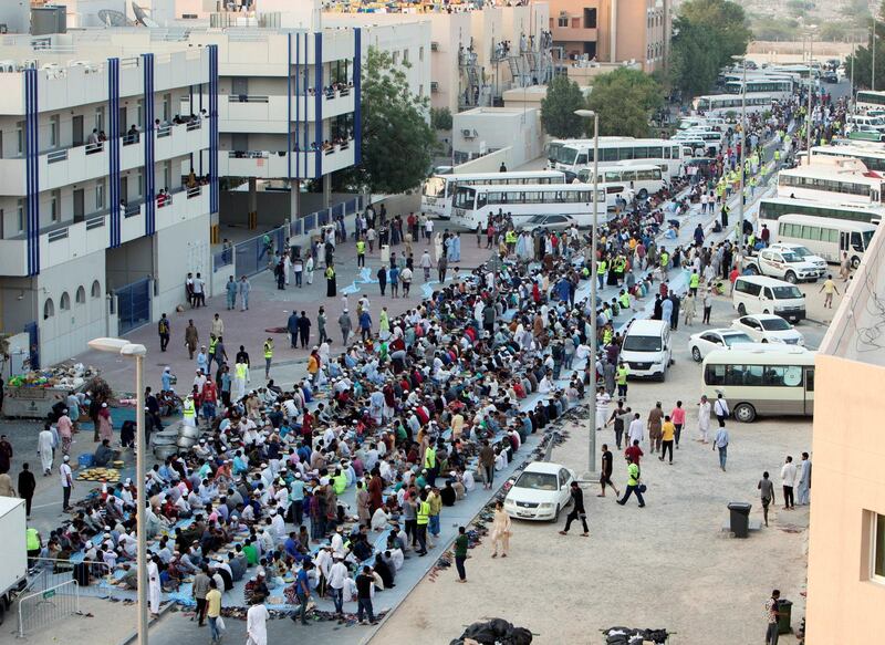 DUBAI, UNITED ARAB EMIRATES -  Workers seating to break their fast.  Dubai Police join hands with Berkeley Assets to serve up Iftar dinner to mark Laylatul Qadr for 10,000 labourers with seating for 5,000 and another 5,000 laborers will go home with meal boxes in Al Muhaisnah, Dubai.  Ruel Pableo for The National