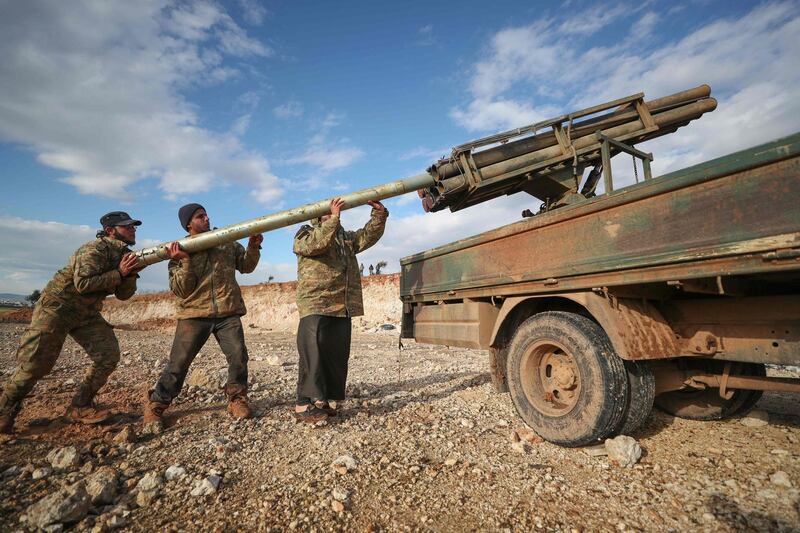 Syrian rebel fighters load a Grad rocket launcher in northwestern Syria.  AFP