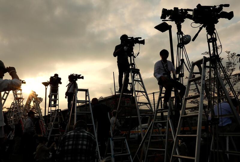 Members of the media prepare for coverage of the release of former Nissan Motor chairman Carlos Ghosn outside the Tokyo Detention Centre.  EPA