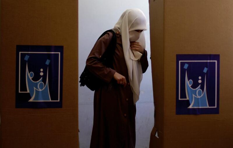 An Iraqi woman walks toward the voting booth to cast her vote at a polling station, for the  Iraqi parliamentary election, in Amman, Jordan. Mohammad Hannon / Jordan