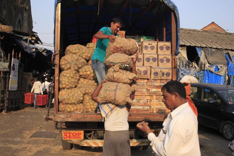 Farm produce is being unloaded at Crawford Market. Subhash Sharma for The National