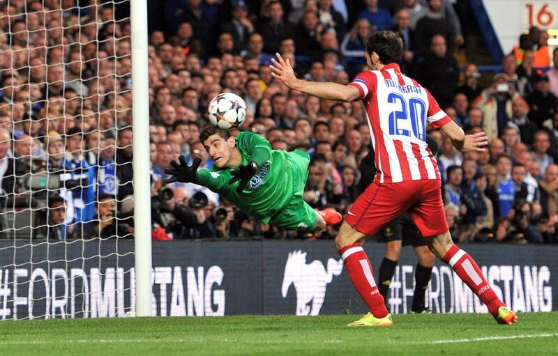 Chelsea striker Fernando Torres (not in picture) scores the opening goal past Atletico Madrid goalkeeper Thibaut Courtois and Atletico Madrid midfielder Juanfran during the Champions League semi-final second leg on Wednesday night. Glyn Kirk / AFP / April 30, 2014