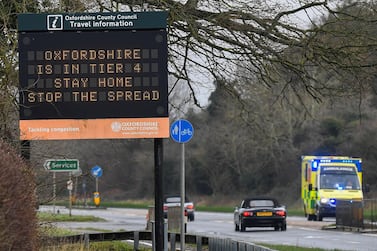 Vehicles drive past a roadside public health information sign as cases of Covid-19 continue to grow in the UK. Reuters