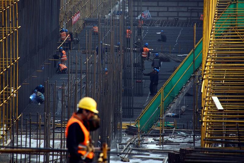 Workers labour at the construction site of the terminal for the Beijing New Airport. Thomas Peter / Reuters