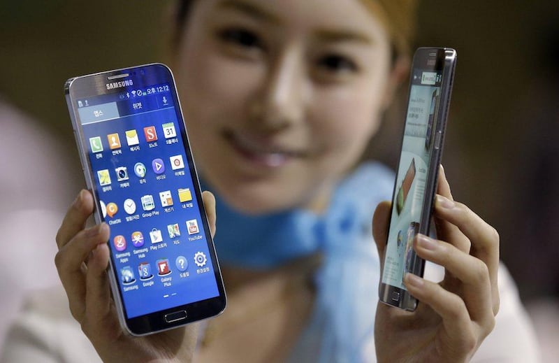A model poses with the Galaxy Round at the Korea Electronics Show in Goyang, west of Seoul. Samsung Electronics said it will release a smartphone with a curved display and a $1,000 price tag. Lee Jin-man / AP Photo