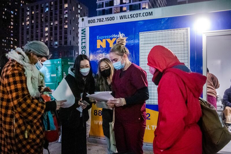 New Yorkers check their Covid-19 results outside a rapid testing centre in Manhattan. AP