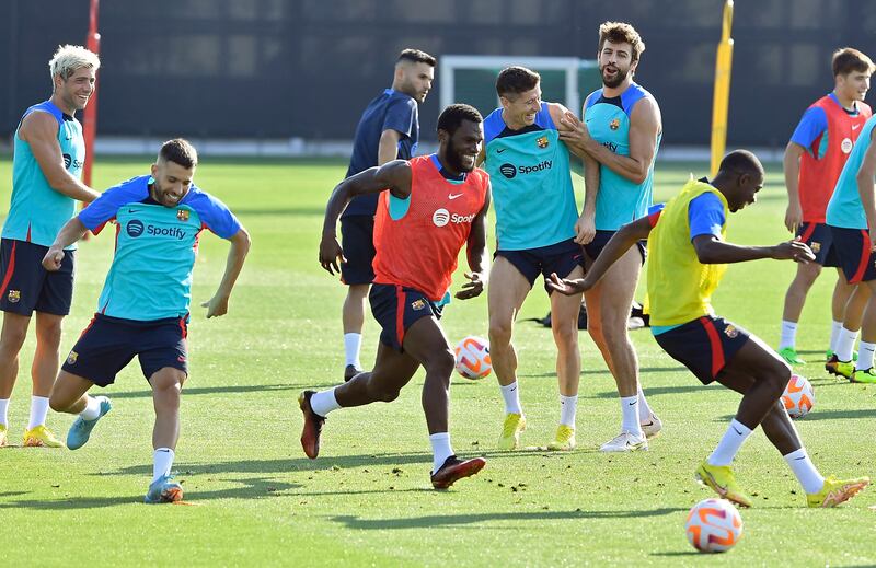 Robert Lewandowski and Gerard Pique with Barca teammates during training. AFP