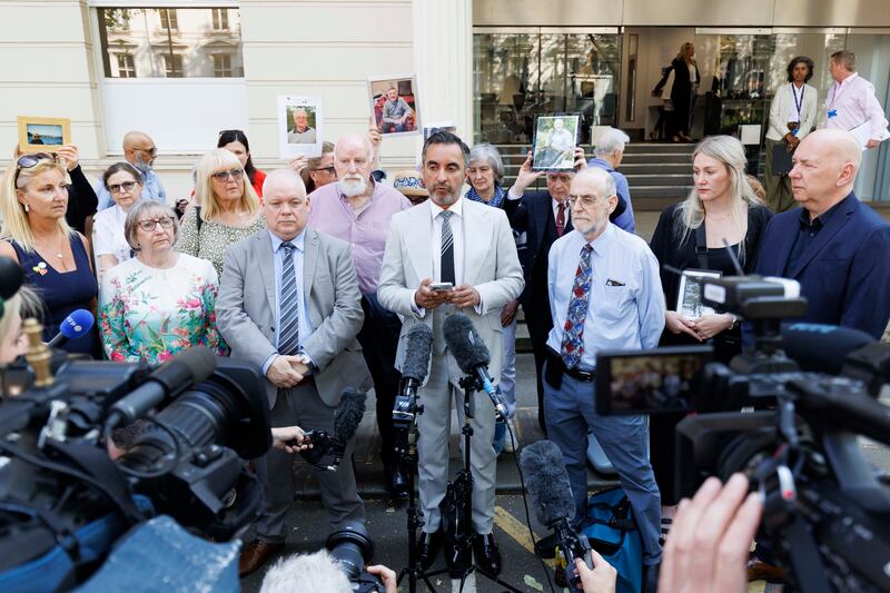 Aamer Anwar (centre), lead solicitor for the Scottish Covid Bereaved group, speaks to the media outside Dorland House. PA