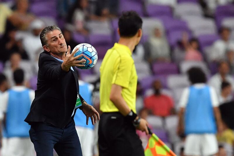 UAE's Argentine coach Edgardo Bauza (L) catches the ball during the 2018 FIFA World Cup qualifier football match between UAE and Saudi Arabia at the Hazza Bin Zayed Stadium in Al-Ain on August 29, 2017. / AFP PHOTO / GIUSEPPE CACACE