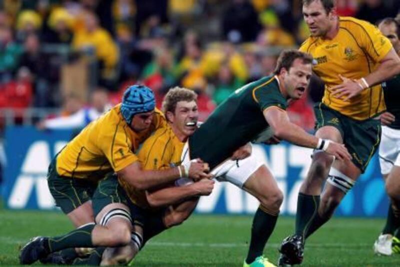 Australia Wallabies' David Pocock (2nd L) and captain James Horwill (L) tackle South Africa Springboks' Francois Hougaard as Rocky Elsom (R) moves in during their Rugby World Cup quarter-final match at Wellington Regional Stadium October 9, 2011. REUTERS/Marcos Brindicci (NEW ZEALAND  - Tags: SPORT RUGBY)   *** Local Caption ***  RWC789_RUGBY-WORLD-_1009_11.JPG