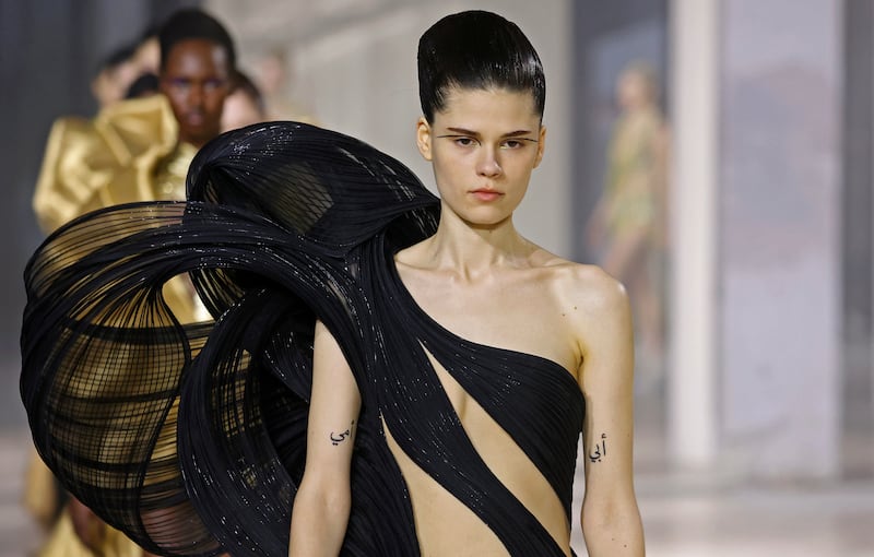 Many looks featured wing-like creations that twisted around his models