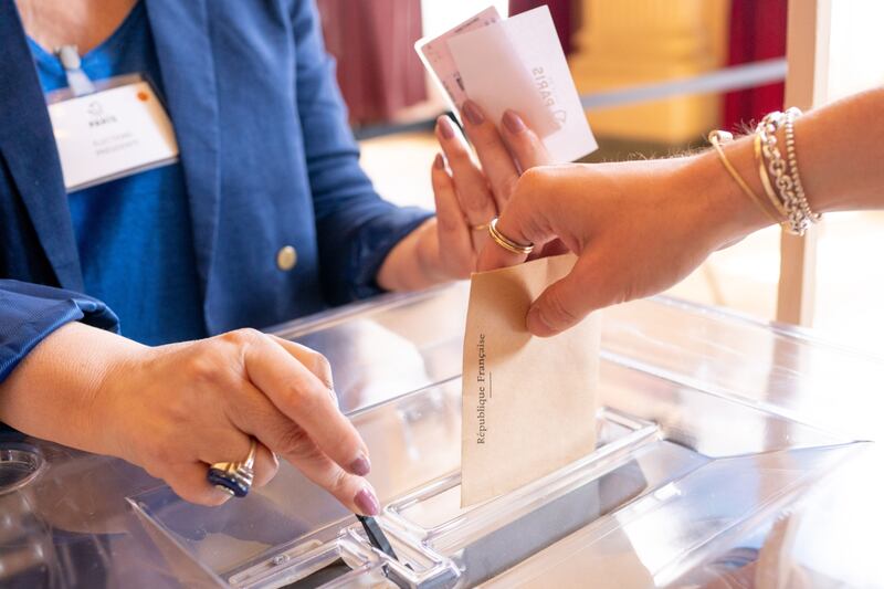 Voters cast their ballots in Paris. Before the poll, Mr Macron had said the country faces chaos if it didn’t hand him an absolute majority. Bloomberg