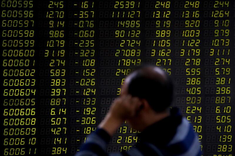 An investor sits in front of an electronic board displaying stock prices at a brokerage house in Beijing, Monday, Sept. 17, 2018. Asian shares were mostly lower Monday on reports that President Donald Trump will soon place tariffs on $200 billion more of Chinese goods, even as officials worked to iron out tensions between the world's two largest economies. (AP Photo/Andy Wong)