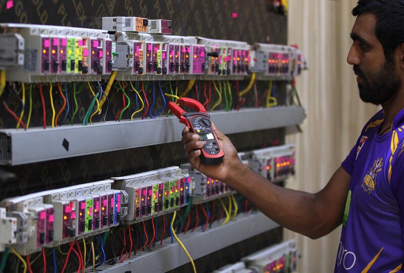 An Iraqi man checks an electric generator supplying homes with electricity in a Baghdad neighbourhood in the Iraqi capital on July 26, 2018.
Temperatures at this time of year regularly exceed 50 degrees celsius (120 fahrenheight), creating enormous demand for electricity, and the public power grid is unable to cope, leaving business owners beholden to private supplies. Experts say at least 40 percent of electricity demand is not met in summer.  / AFP PHOTO / AHMAD AL-RUBAYE