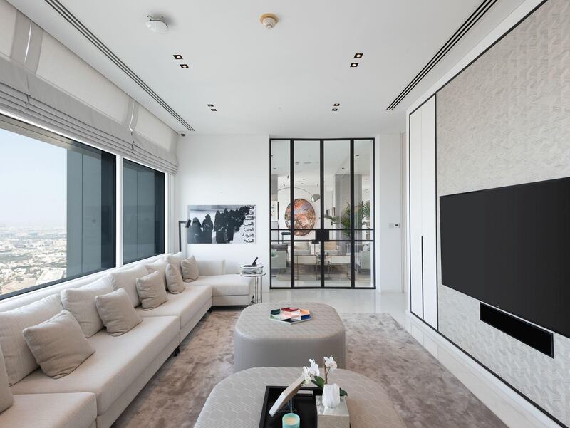 An informal living room, currently being used as a television room. Courtesy Luxhabitat Sotheby's International Realty