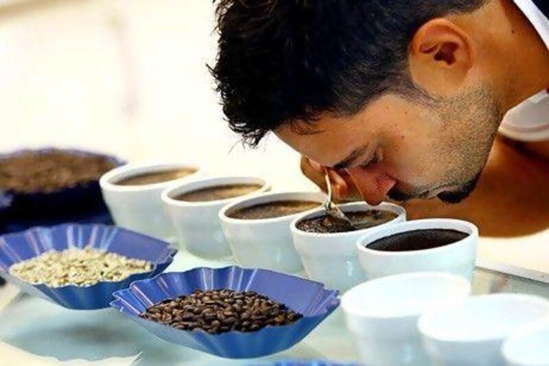 Roastmaster Rosco Franklin smells the coffee at Coffee Planet in Dubai. (Satish Kumar / The National )