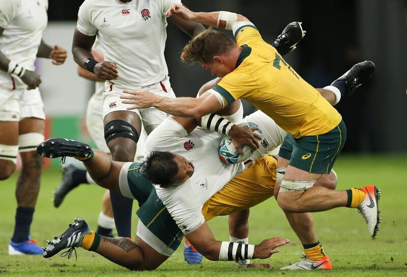 Billy Vunipola of England (C-bottom) is tackled by Michael Hooper (R) of Australia during the Rugby World Cup quarter-final match between England and Australia, in Oita, Japan.  EPA