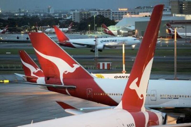 (FILES) This file photo taken on June 12, 2011 shows Qantas planes on the tarmac at Sydney International Airport. Embattled Australian flag carrier Qantas said May 22, 2012 it will split its loss-making international arm from its domestic operations as part of a drive to transform the airline. AFP PHOTO / FILES / Greg WOOD
 *** Local Caption ***  574365-01-08.jpg